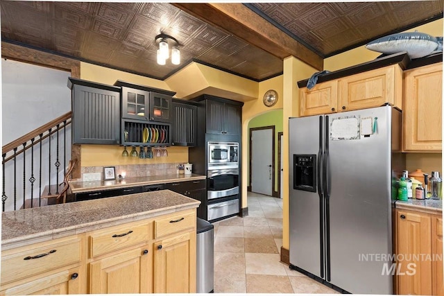 204 7th Ave N, Twin Falls, ID 83301 - kitchen featuring stainless steel appliances, an ornate ceiling, glass insert cabinets, light brown cabinets, and arched walkways
