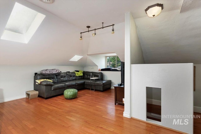 204 7th Ave N, Twin Falls, ID 83301 - living room with a skylight, vaulted ceiling, and light wood finished floors