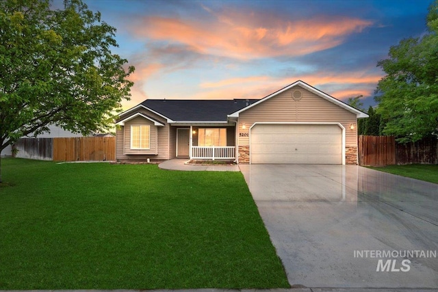 5201 Worth Way, Caldwell, ID 83607 - ranch-style house featuring a garage, driveway, stone siding, and covered porch