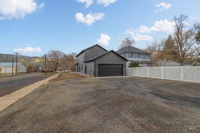 view of home's exterior featuring a mountain view and a garage