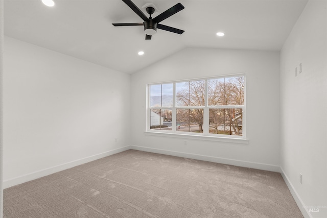 empty room featuring carpet flooring, ceiling fan, and lofted ceiling