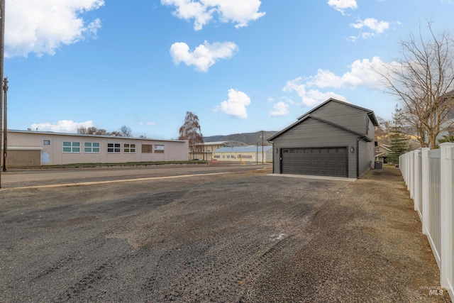 view of front facade with a mountain view and a garage