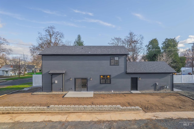 back of property featuring a patio and a lawn