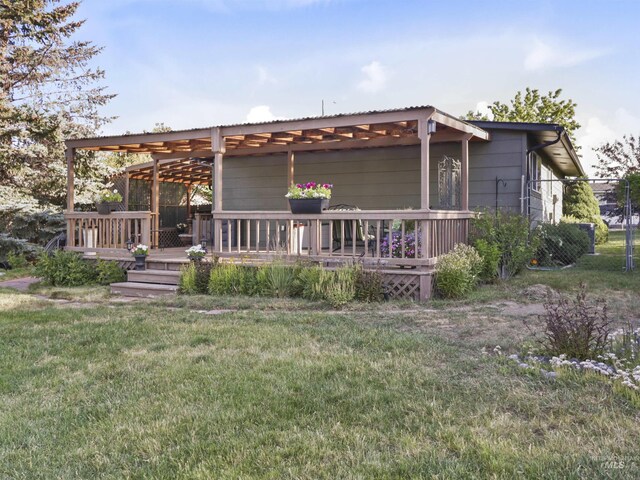 143 E Morris Ct, Kuna, ID 83634 - rear view of property featuring a deck and a yard