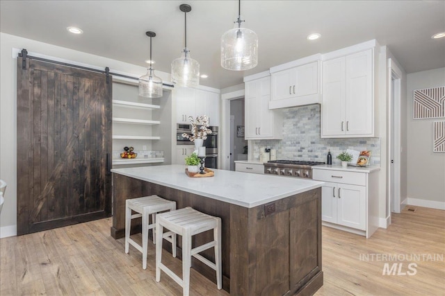 1864 N Highbury Way, Eagle, ID 83616 - kitchen with light countertops, open shelves, a center island, white cabinets, and a kitchen breakfast bar