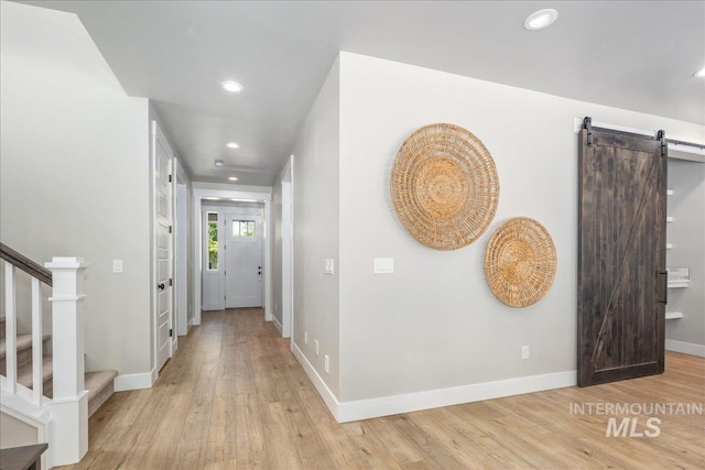 1864 N Highbury Way, Eagle, ID 83616 - hallway with recessed lighting, light wood-style floors, a barn door, and stairway