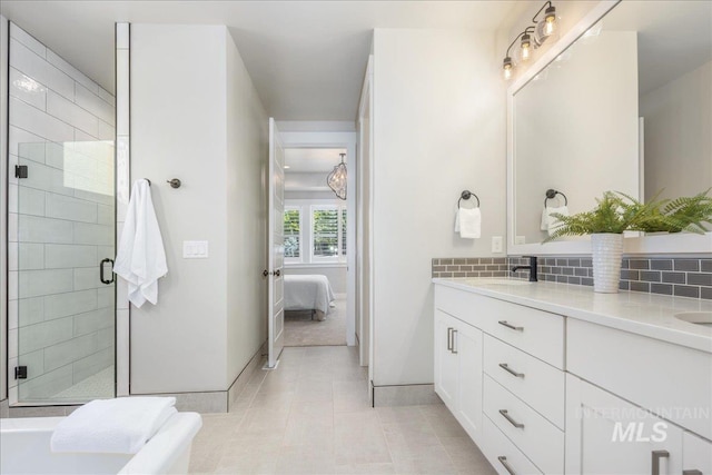 1864 N Highbury Way, Eagle, ID 83616 - bathroom with ensuite bath, double vanity, a shower stall, tile patterned floors, and backsplash