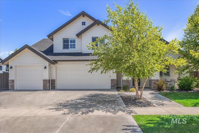 1864 N Highbury Way, Eagle, ID 83616 - view of front of house with stone siding, concrete driveway, an attached garage, and a shingled roof