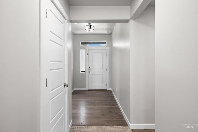 hall featuring baseboards and wood finished floors