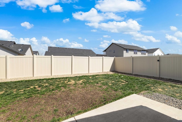 view of yard with a patio area and a fenced backyard
