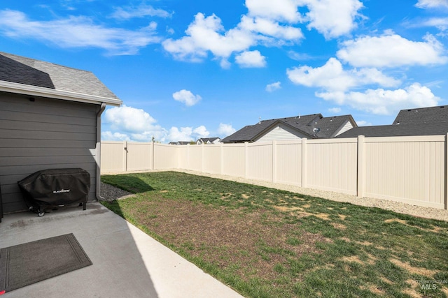 view of yard featuring a patio area and a fenced backyard