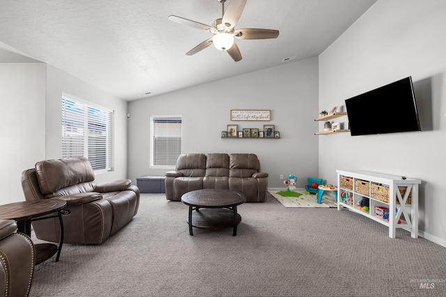 carpeted living room with vaulted ceiling, a ceiling fan, visible vents, and baseboards