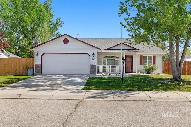 ranch-style house with fence, an attached garage, a front yard, covered porch, and driveway