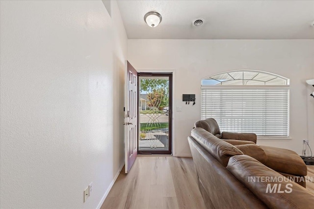 entryway featuring light wood-style floors and baseboards