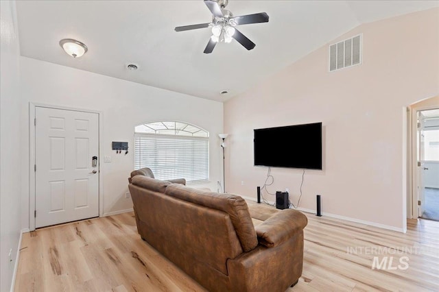 living area with ceiling fan, visible vents, vaulted ceiling, and light wood-type flooring