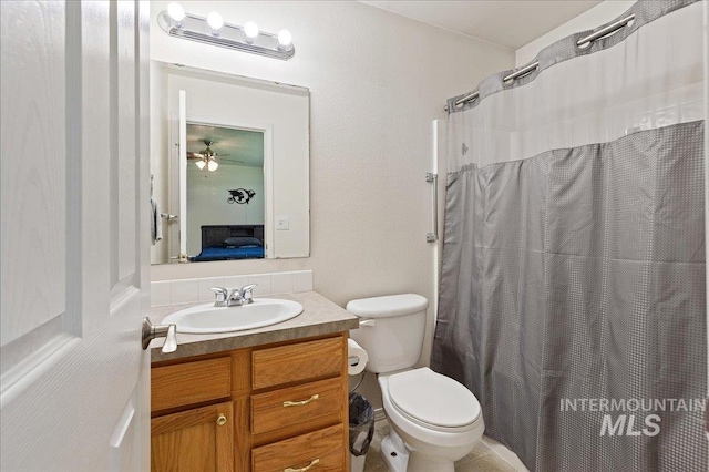 ensuite bathroom with vanity, ensuite bathroom, toilet, and curtained shower
