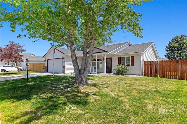 single story home with a front yard, fence, covered porch, and driveway