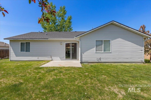 back of house with a lawn, fence, and a patio