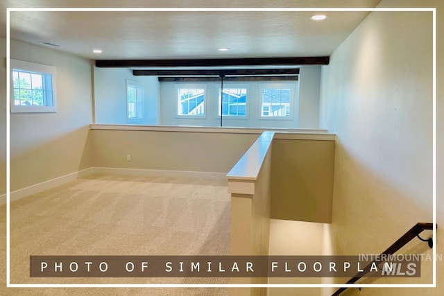 interior space featuring visible vents, baseboards, carpet floors, recessed lighting, and beamed ceiling