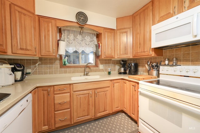 kitchen featuring white appliances, sink, and backsplash