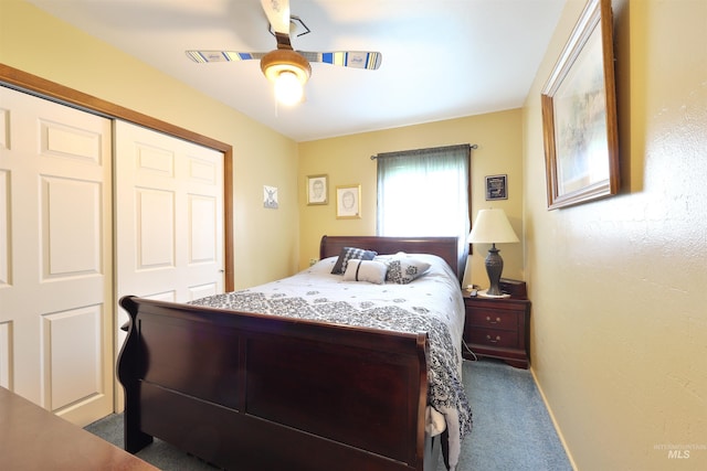 bedroom with ceiling fan, a closet, and dark carpet