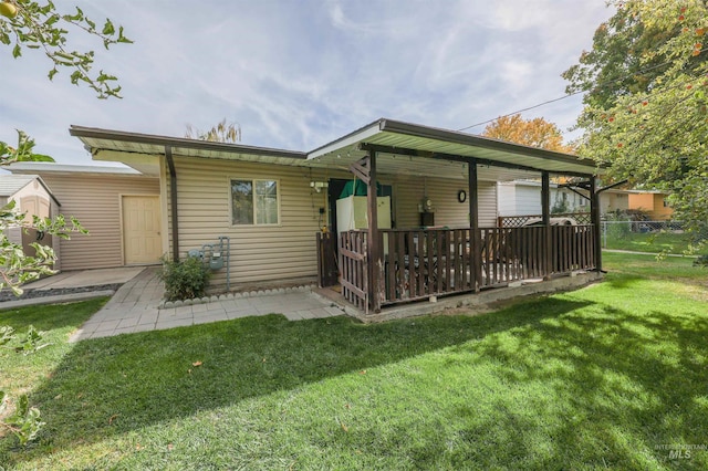 rear view of house with a lawn and a patio