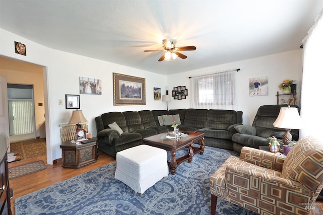 living room featuring hardwood / wood-style flooring and ceiling fan