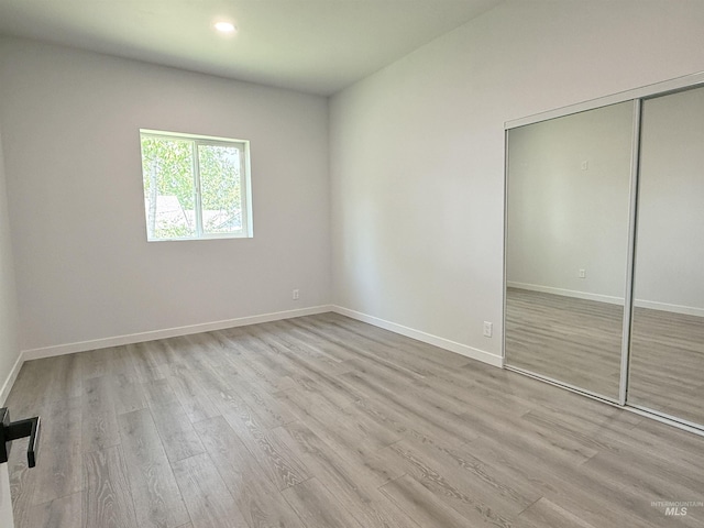 304 N C St, Grangeville, ID 83530 - unfurnished bedroom featuring wood finished floors, a closet, baseboards, and recessed lighting