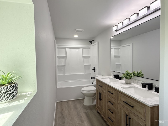 304 N C St, Grangeville, ID 83530 - bathroom with wood finished floors, double vanity, toilet, and washtub / shower combination