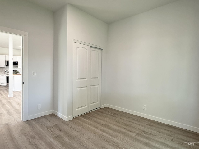 304 N C St, Grangeville, ID 83530 - unfurnished bedroom with light wood-style floors, baseboards, and a closet