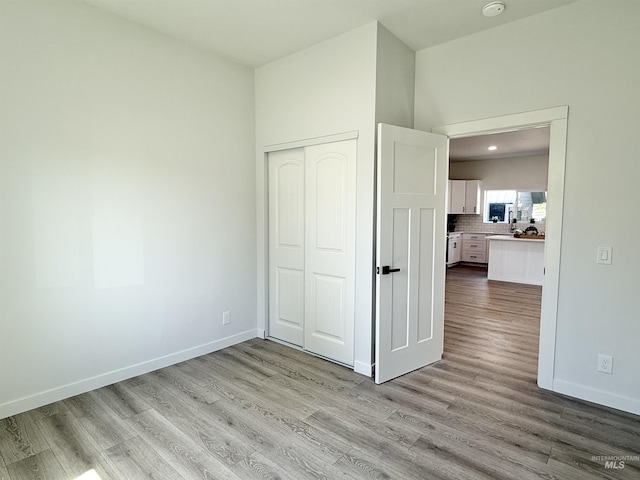 304 N C St, Grangeville, ID 83530 - unfurnished bedroom with wood finished floors, a closet, baseboards, and recessed lighting