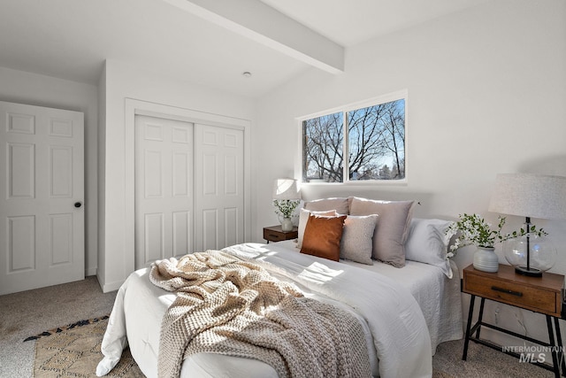 bedroom featuring carpet flooring, a closet, and vaulted ceiling with beams