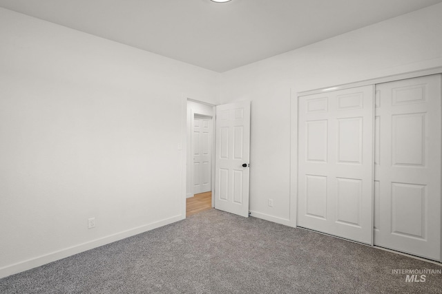 unfurnished bedroom with a closet and carpet flooring