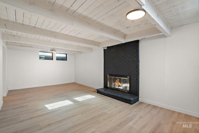 basement with wood ceiling, light hardwood / wood-style floors, and a brick fireplace