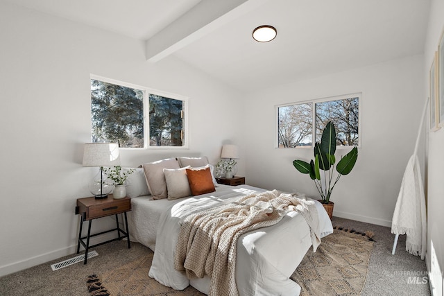 bedroom with vaulted ceiling with beams and carpet floors