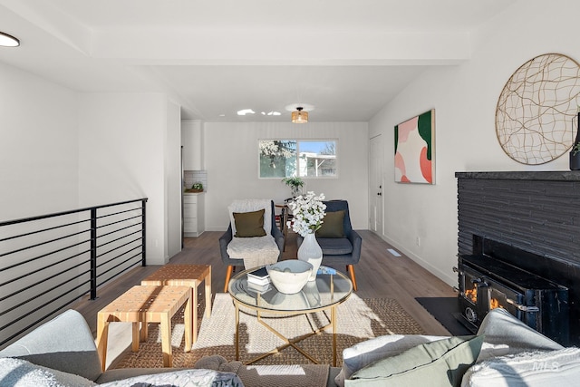 living room featuring dark hardwood / wood-style floors and beamed ceiling