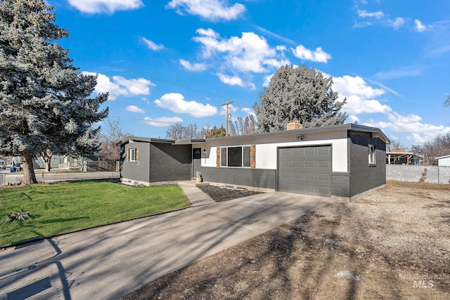 view of front of house featuring a garage and a front lawn