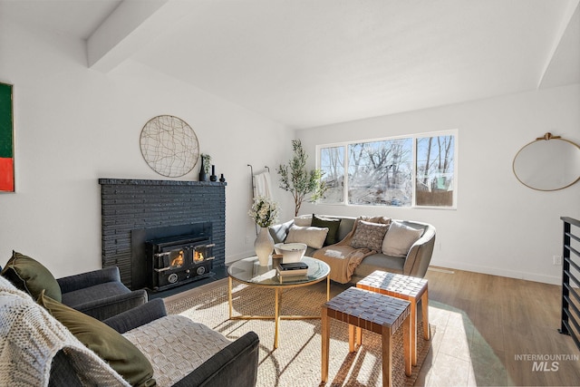 living room with beamed ceiling and light hardwood / wood-style floors