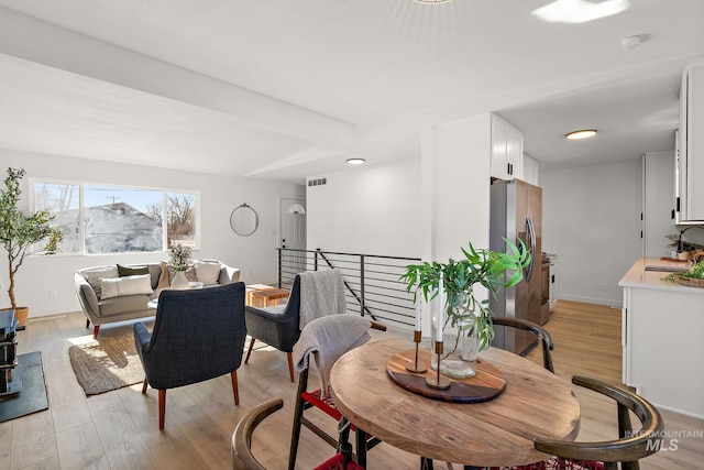 dining room featuring sink and light hardwood / wood-style floors