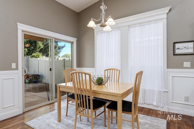 1928 E Mountain Man Dr, Meridian, ID 83646 - dining space featuring wainscoting, a decorative wall, and a notable chandelier