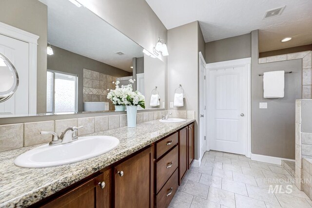 1928 E Mountain Man Dr, Meridian, ID 83646 - bathroom featuring a sink, walk in shower, double vanity, and visible vents