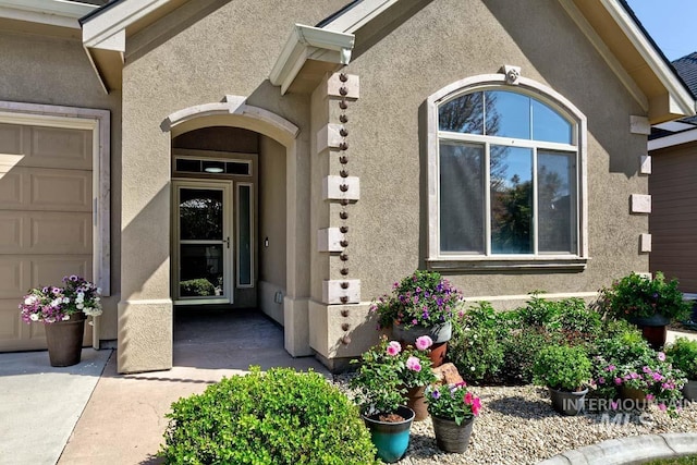 1928 E Mountain Man Dr, Meridian, ID 83646 - property entrance with an attached garage and stucco siding
