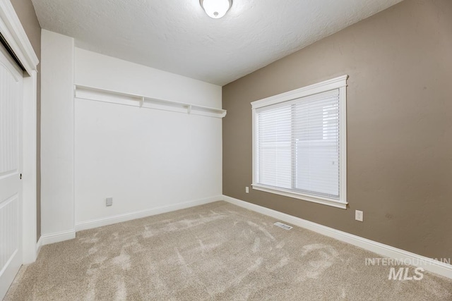 1928 E Mountain Man Dr, Meridian, ID 83646 - unfurnished bedroom with visible vents, baseboards, carpet floors, and a closet