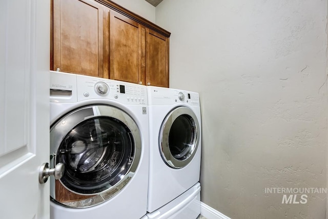 1928 E Mountain Man Dr, Meridian, ID 83646 - laundry room with baseboards, cabinet space, and washer and clothes dryer