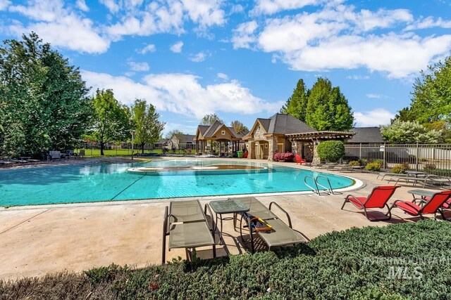 1928 E Mountain Man Dr, Meridian, ID 83646 - pool with a patio area, fence, and a jacuzzi