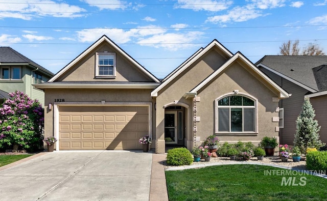 1928 E Mountain Man Dr, Meridian, ID 83646 - view of front facade featuring a garage, stucco siding, concrete driveway, and a front yard
