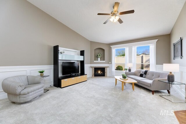 1928 E Mountain Man Dr, Meridian, ID 83646 - living area with ceiling fan, a decorative wall, carpet floors, a fireplace with flush hearth, and lofted ceiling
