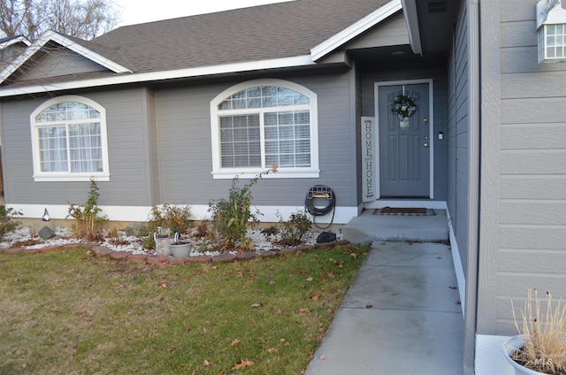 property entrance with a yard