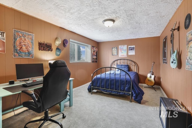 bedroom featuring a textured ceiling and carpet