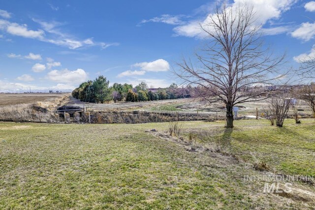 view of yard with a rural view